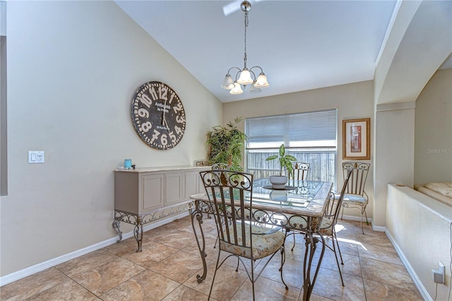 dining area featuring baseboards, lofted ceiling, and an inviting chandelier