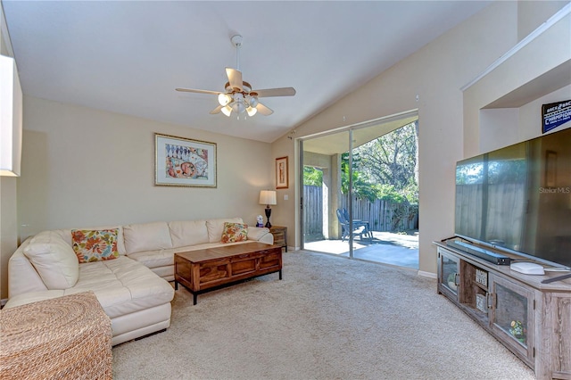 living area featuring carpet floors, lofted ceiling, and a ceiling fan