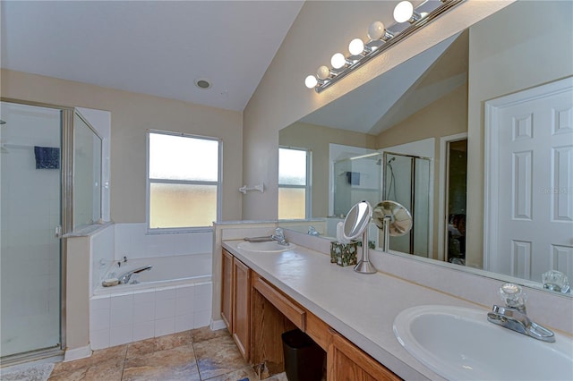 bathroom with a sink, a garden tub, a stall shower, and vaulted ceiling