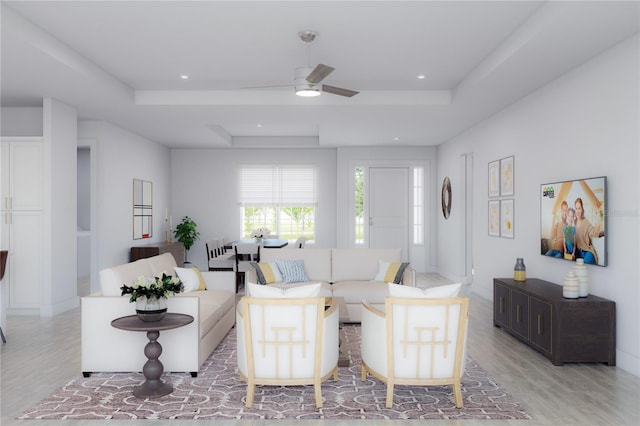 living room featuring a raised ceiling, recessed lighting, light wood-style floors, and ceiling fan