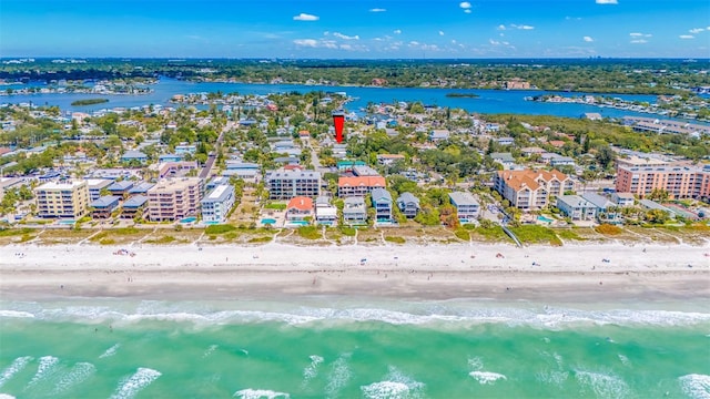 birds eye view of property featuring a beach view and a water view