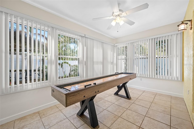 playroom with baseboards, ceiling fan, and tile patterned flooring