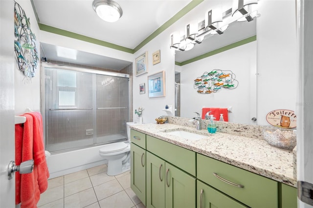 bathroom featuring tile patterned floors, toilet, shower / bath combination with glass door, and vanity