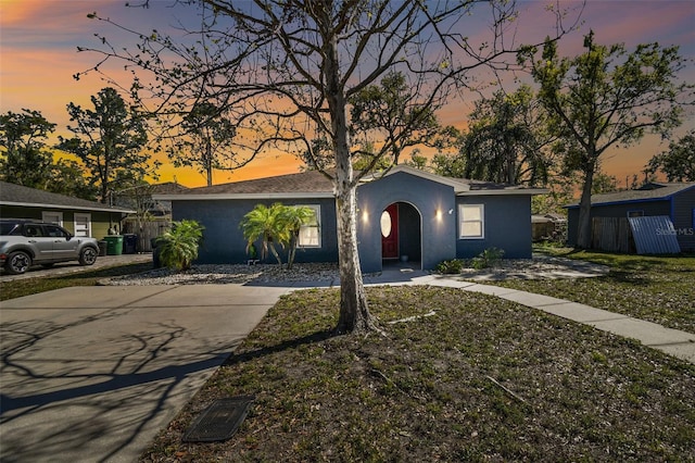 view of front of property with stucco siding and fence