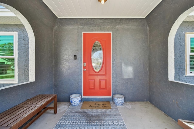 entrance to property with stucco siding