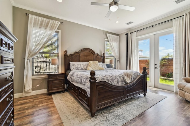 bedroom with wood finished floors, crown molding, baseboards, and access to outside