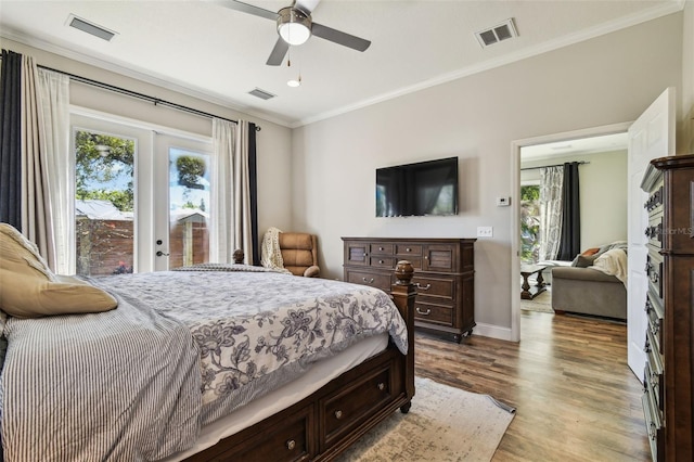 bedroom with wood finished floors, visible vents, french doors, and ornamental molding