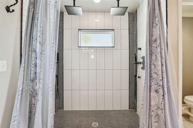 bathroom featuring a stall shower and toilet