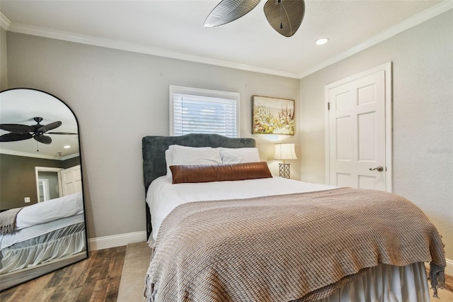 bedroom with recessed lighting, baseboards, wood finished floors, and crown molding