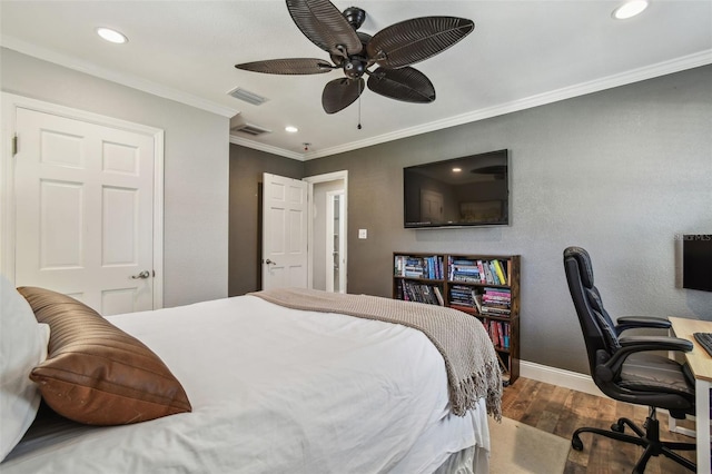 bedroom with baseboards, wood finished floors, visible vents, and ornamental molding