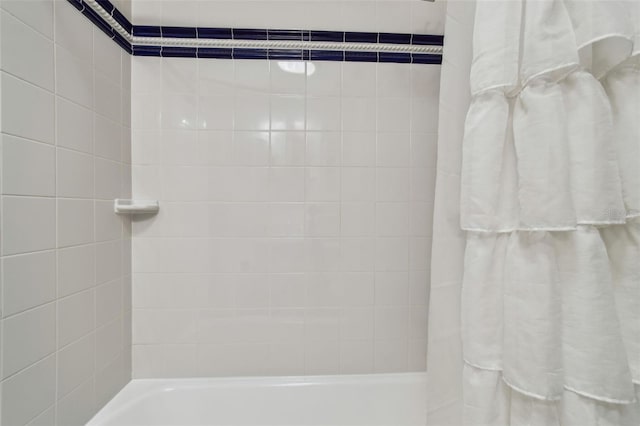 bathroom featuring shower / tub combo with curtain