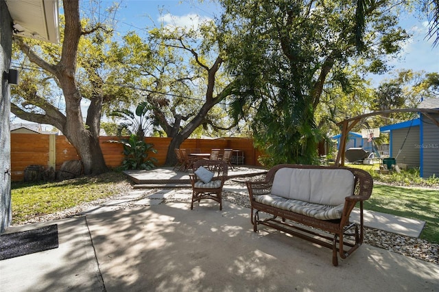 view of patio with outdoor dining area, outdoor lounge area, and fence