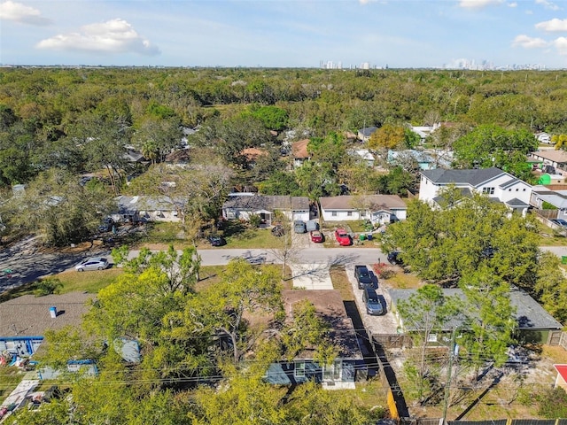 birds eye view of property featuring a wooded view