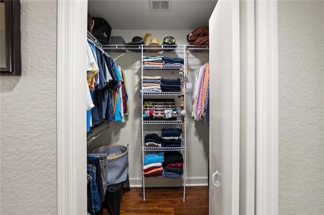 spacious closet featuring wood finished floors and visible vents