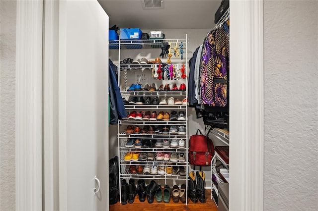 spacious closet with wood finished floors and visible vents