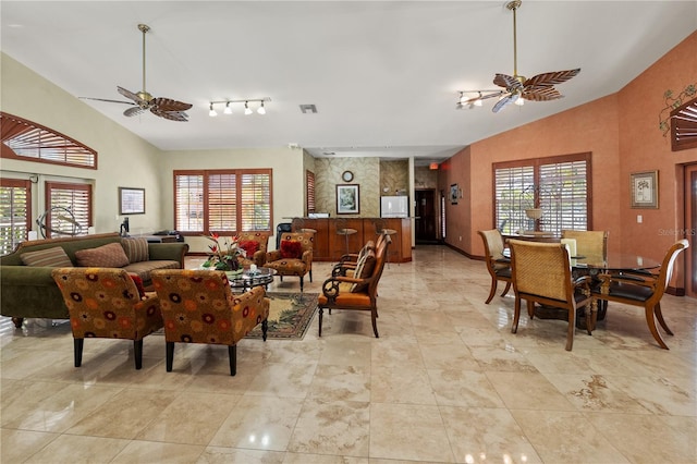 living room featuring a wealth of natural light, high vaulted ceiling, and ceiling fan