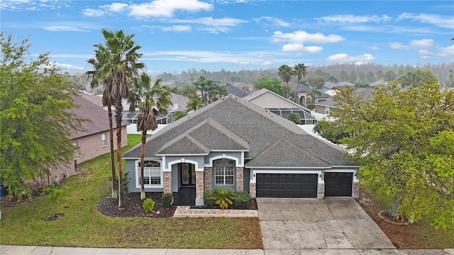 view of front of property featuring a front yard, a shingled roof, concrete driveway, a garage, and a residential view