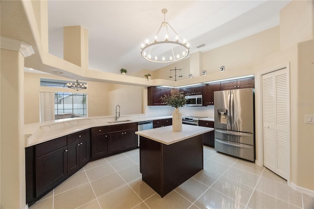 kitchen featuring light countertops, light tile patterned flooring, a notable chandelier, stainless steel appliances, and a sink