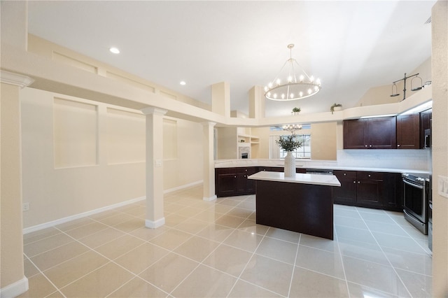 kitchen featuring stainless steel appliances, dark brown cabinetry, an inviting chandelier, light countertops, and light tile patterned floors