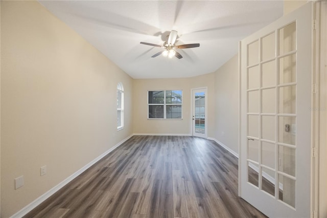 spare room with ceiling fan, baseboards, and dark wood finished floors