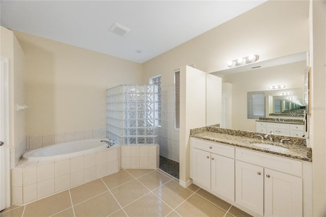 full bathroom featuring visible vents, walk in shower, a garden tub, tile patterned floors, and vanity