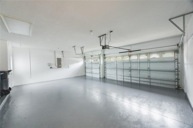 garage featuring electric panel and a garage door opener