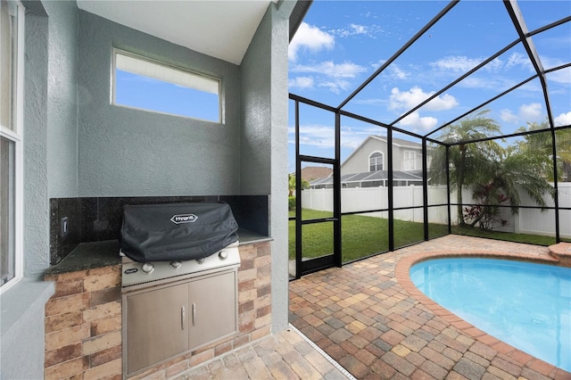 view of swimming pool with a fenced in pool, fence, glass enclosure, area for grilling, and a patio