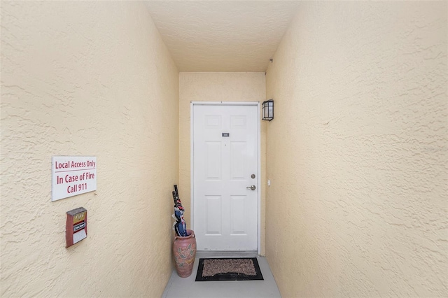 doorway to property with stucco siding