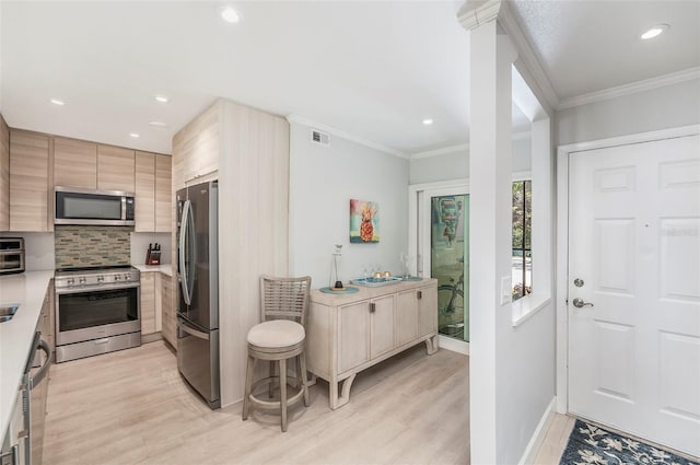 kitchen featuring tasteful backsplash, visible vents, crown molding, light countertops, and appliances with stainless steel finishes