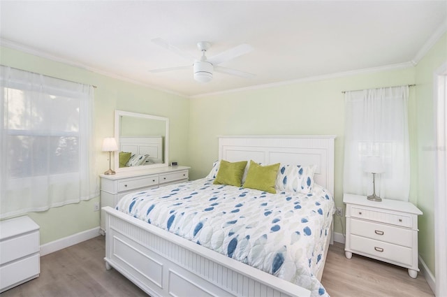 bedroom with light wood-type flooring, baseboards, a ceiling fan, and crown molding