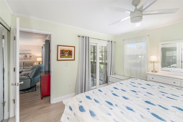 bedroom with baseboards, crown molding, light wood-style floors, and access to outside