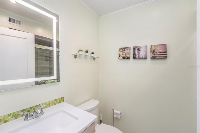 full bath with vanity, visible vents, ornamental molding, a shower stall, and toilet