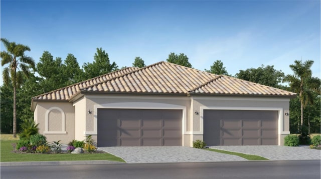 mediterranean / spanish-style house featuring stucco siding, decorative driveway, and a tile roof