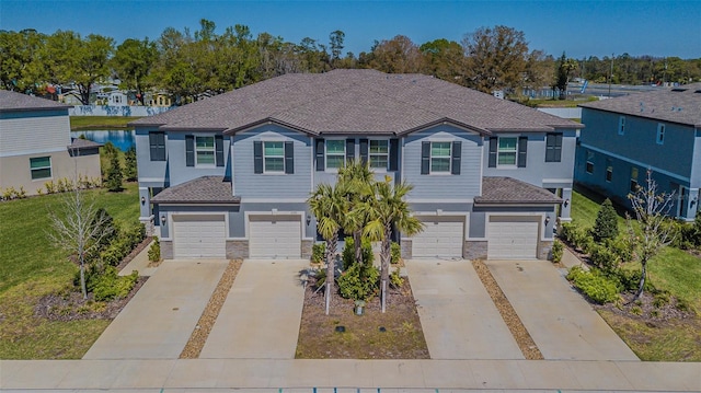 view of front facade featuring concrete driveway and a garage