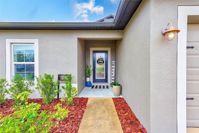 doorway to property with stucco siding