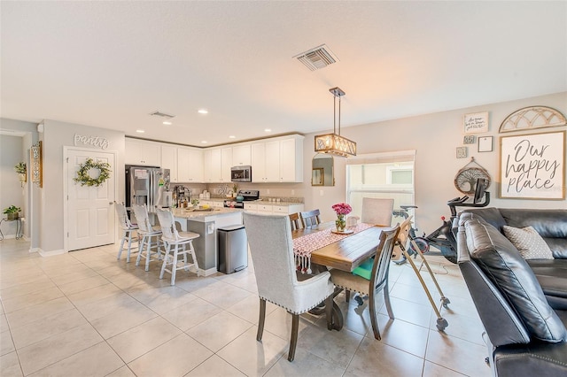 dining area with light tile patterned flooring, visible vents, and recessed lighting