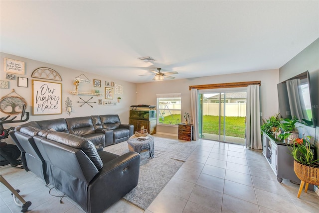 living area with light tile patterned floors, visible vents, and ceiling fan