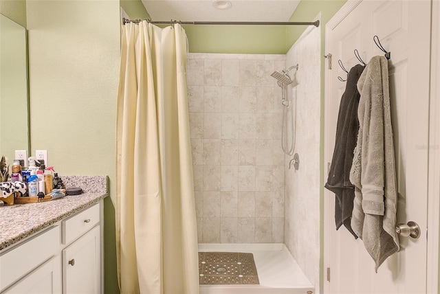 bathroom with a stall shower and vanity