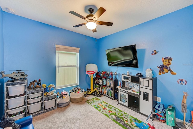 rec room featuring a ceiling fan and carpet flooring