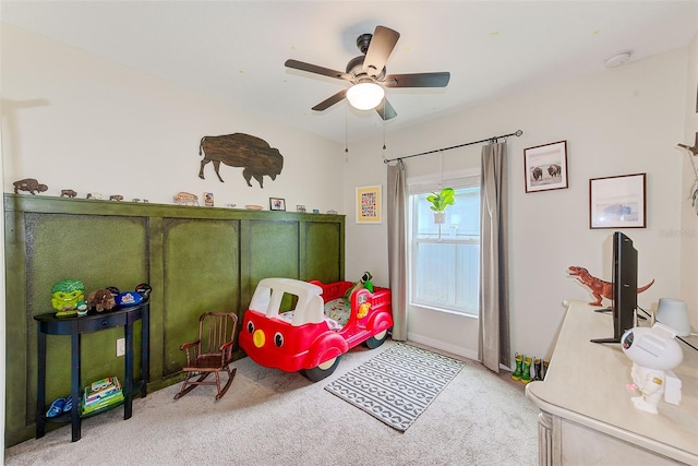 carpeted bedroom featuring baseboards and a ceiling fan