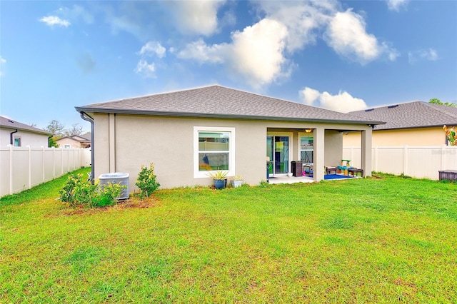 back of house with a patio area, cooling unit, a fenced backyard, and a lawn