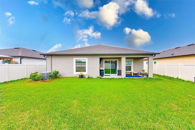 rear view of property with a patio, a yard, a fenced backyard, and stucco siding