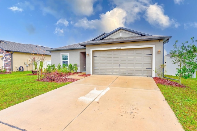 single story home featuring stucco siding, fence, concrete driveway, an attached garage, and a front yard