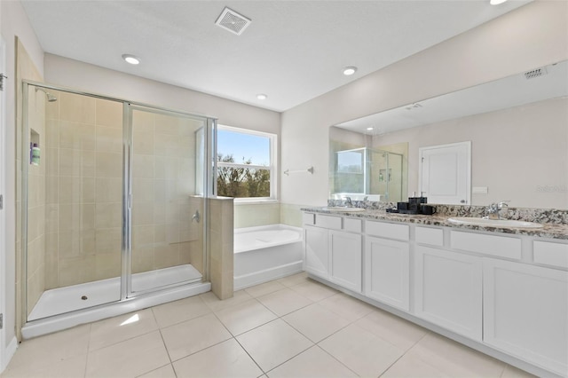 bathroom with tile patterned floors, visible vents, a sink, a shower stall, and a bath