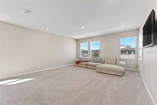 living room with recessed lighting, baseboards, visible vents, and light carpet