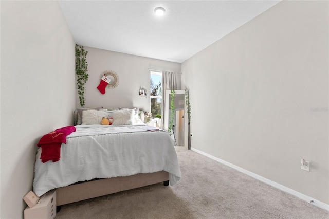 carpeted bedroom featuring baseboards