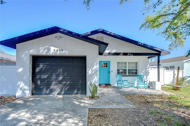 single story home with an attached garage, fence, driveway, and stucco siding