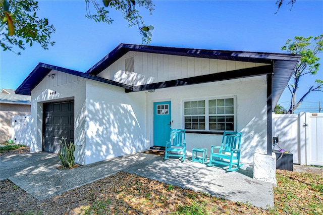 view of front of property with a garage and fence