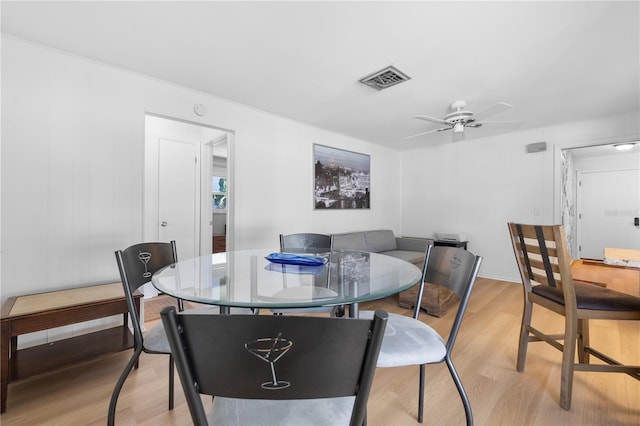 dining room with visible vents, light wood-style floors, and a ceiling fan