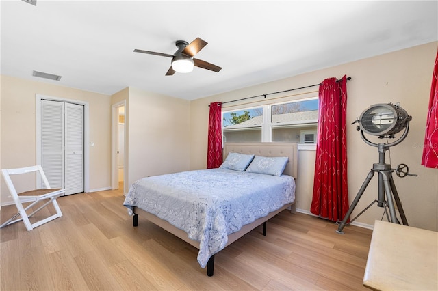 bedroom with a ceiling fan, light wood-style flooring, baseboards, and visible vents